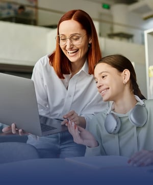 A counselor and student sitting together at a desk reviewing study materials and a tablet to craft and refine their Common App activity list and application narrative.