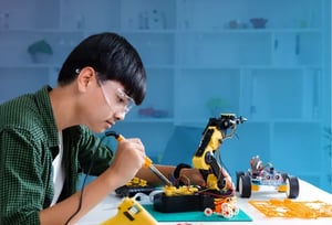 A student exploring his interest in robotics, representing the webinar 