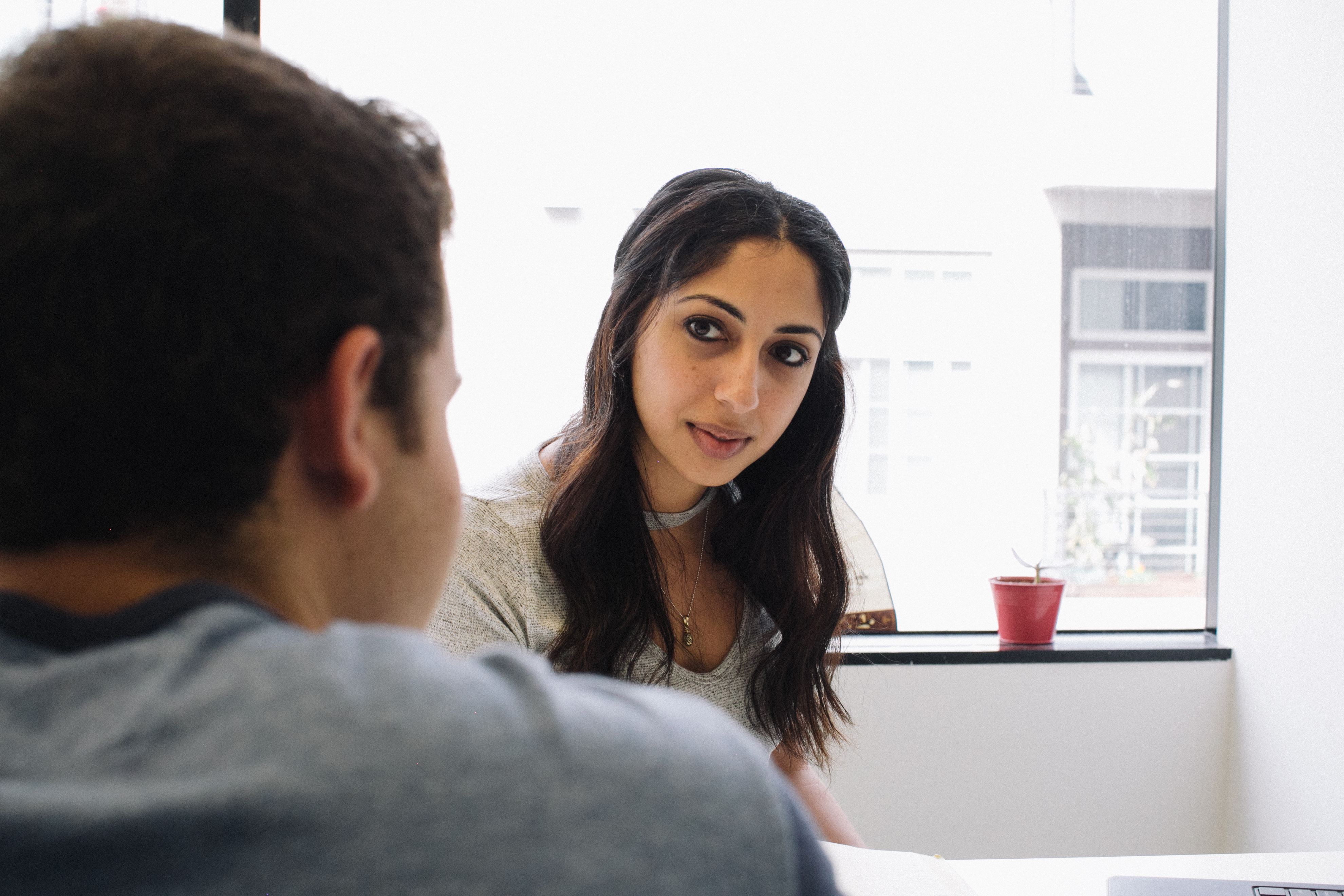 Student meeting with their college counselor in person